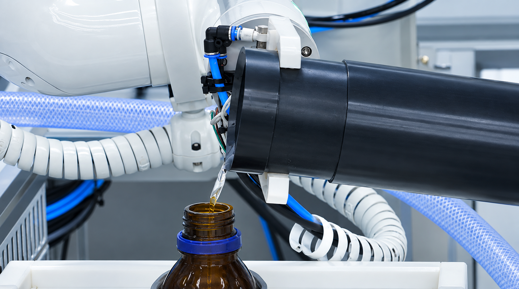 Indy robot dispensing liquid reagent into an amber bottle using a custom dispensing tool